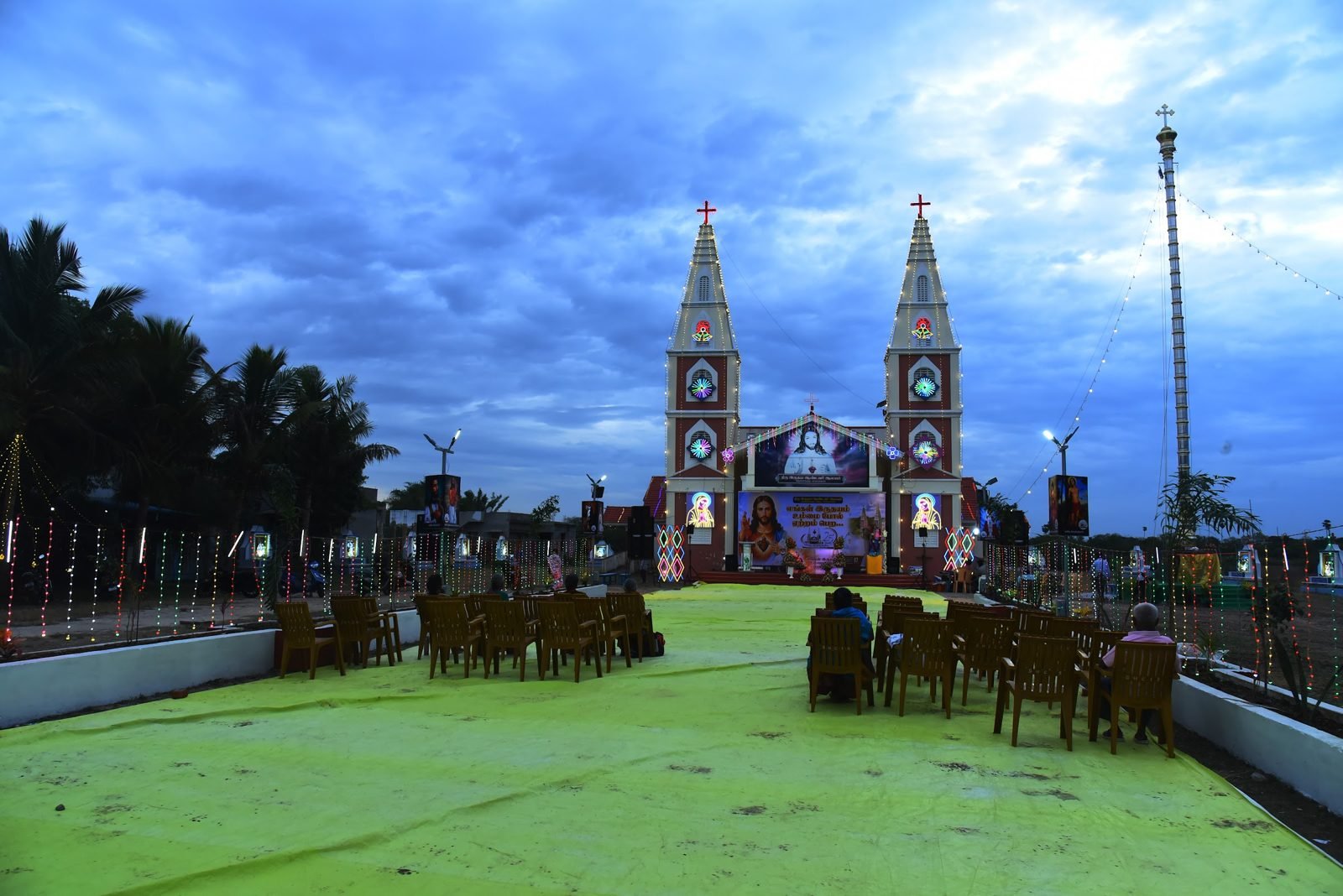 Sacred Heart Church at dusk, prepared for the jubilee flag hoisting